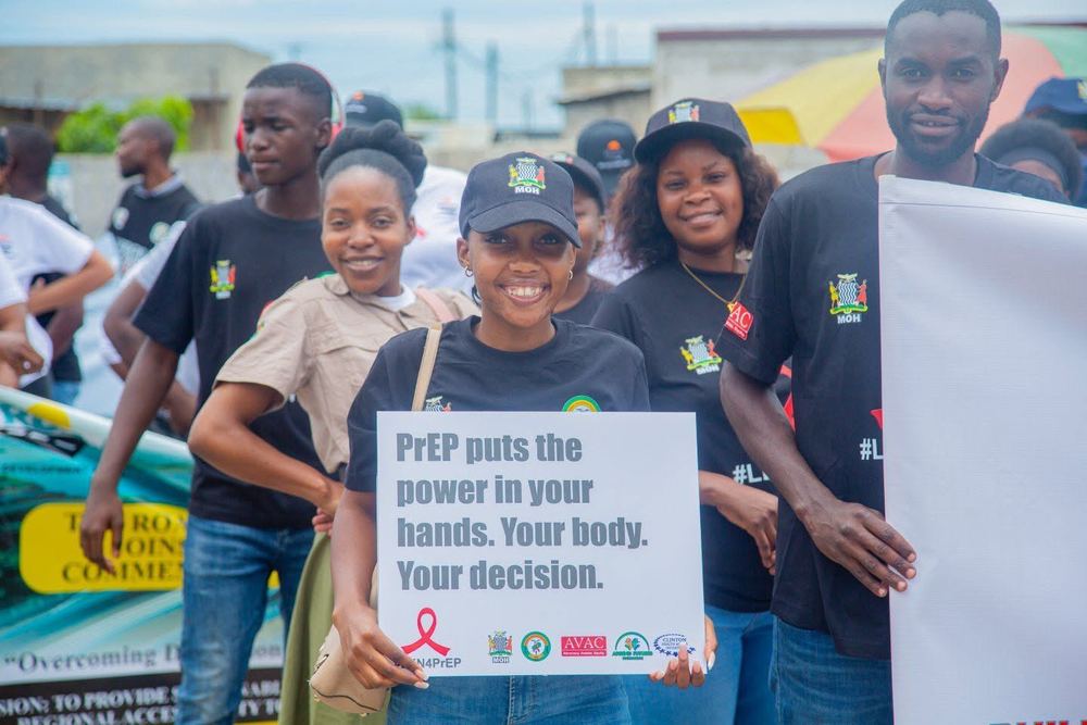 A young advocate holding a PrEP message at World AIDS Day 2025
